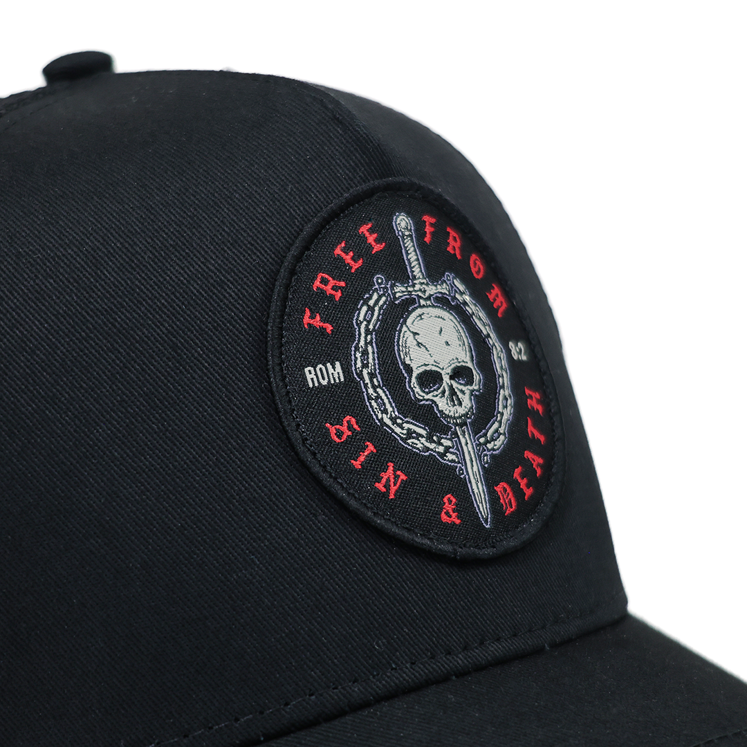 Black cap with a skull and sword design and text on a white background
