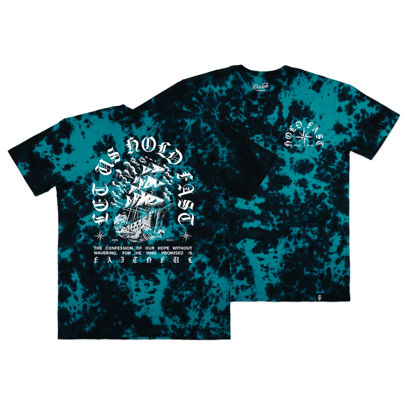 Front and back views of a short-sleeve Christian t-shirt featuring a teal and black tie-dye pattern. The back view displays a large white graphic with gothic text reading Hold Fast based on Hebrews 10:23, surrounding a ship illustration, while the front view shows a smaller matching white graphic on the left chest.
