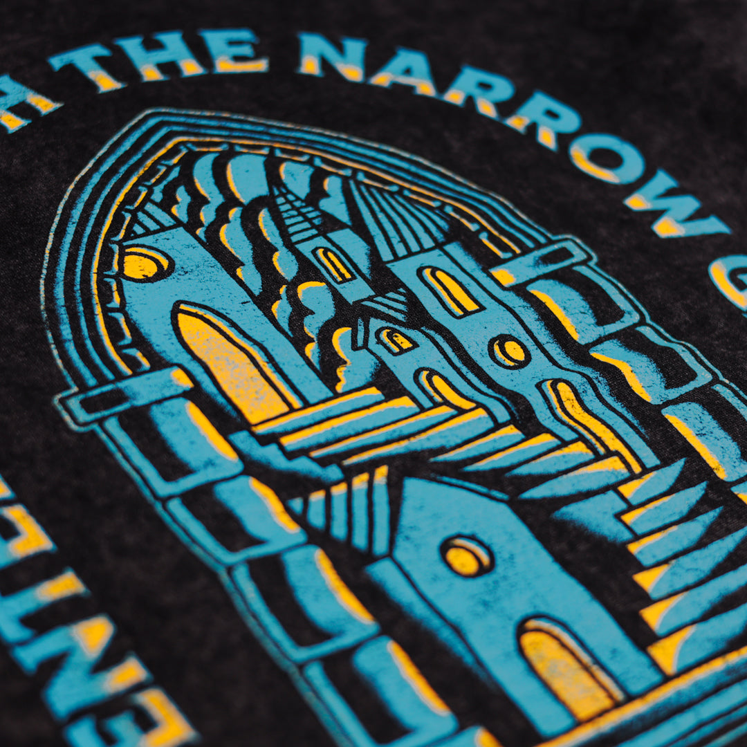 Close-up of a black hoodie with blue and yellow graphic design and text.
