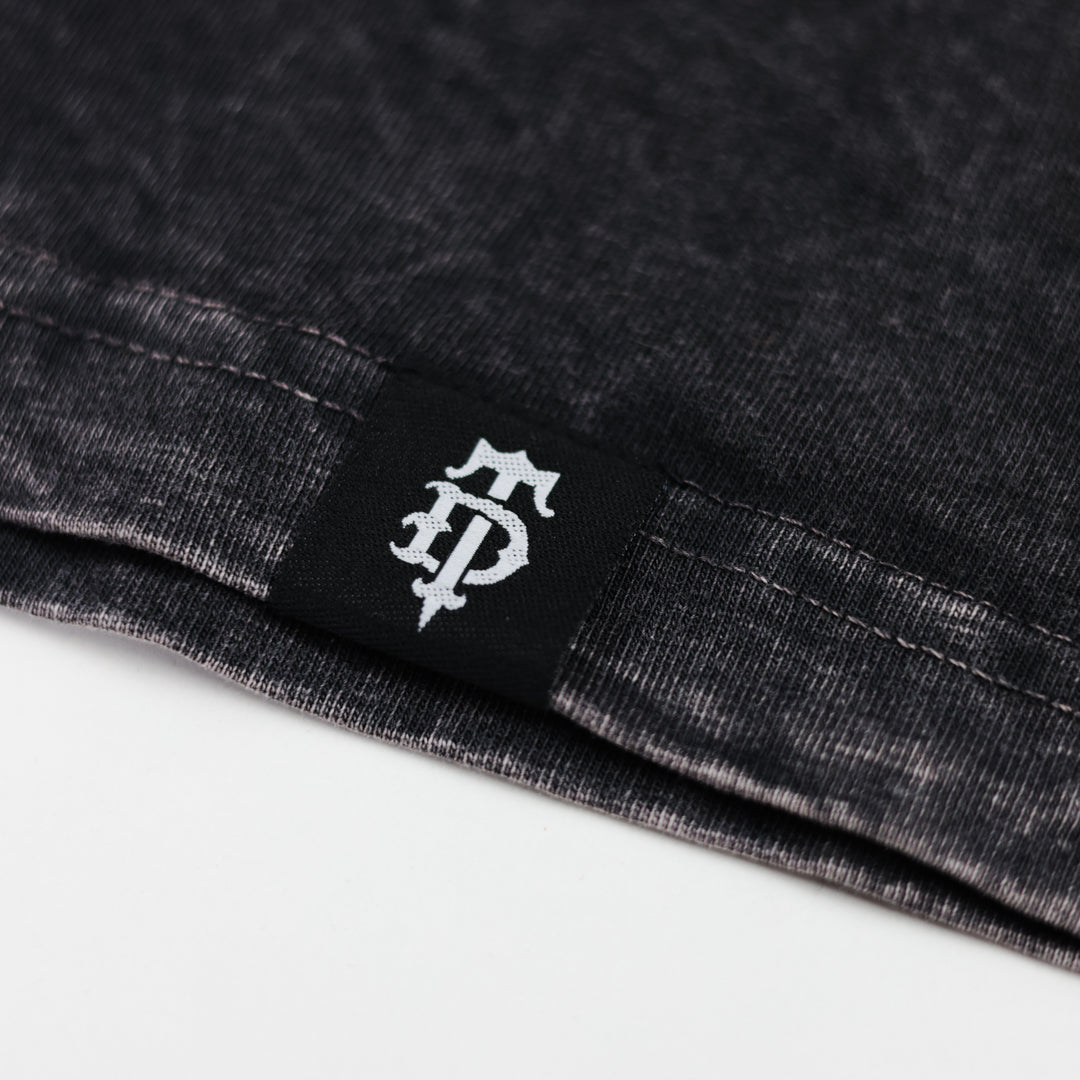 Close-up of a black label with a logo on a dark fabric background