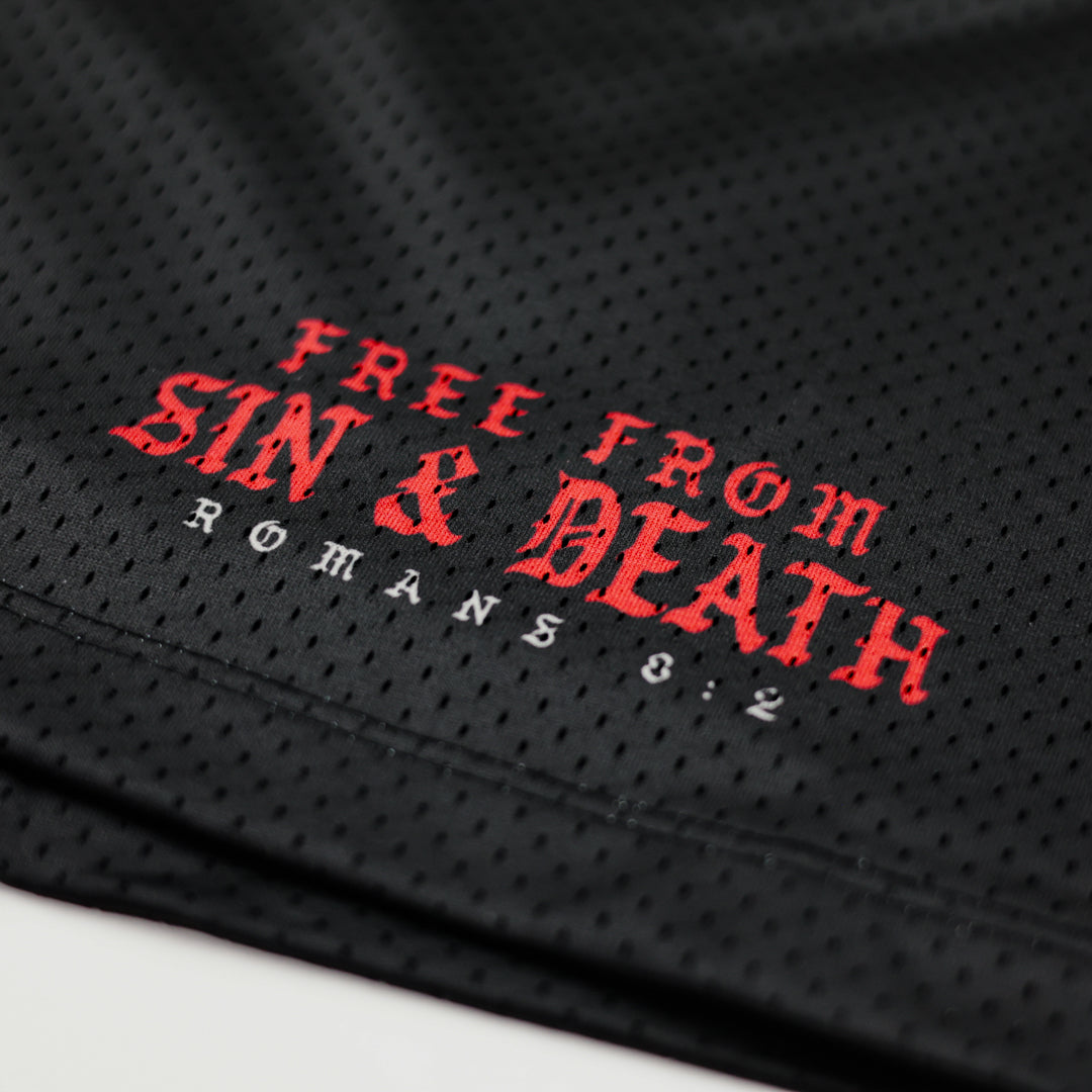 Black mesh fabric with red and white text 'FREE FROM SIN & DEATH ROMANS 8:2' on a white background