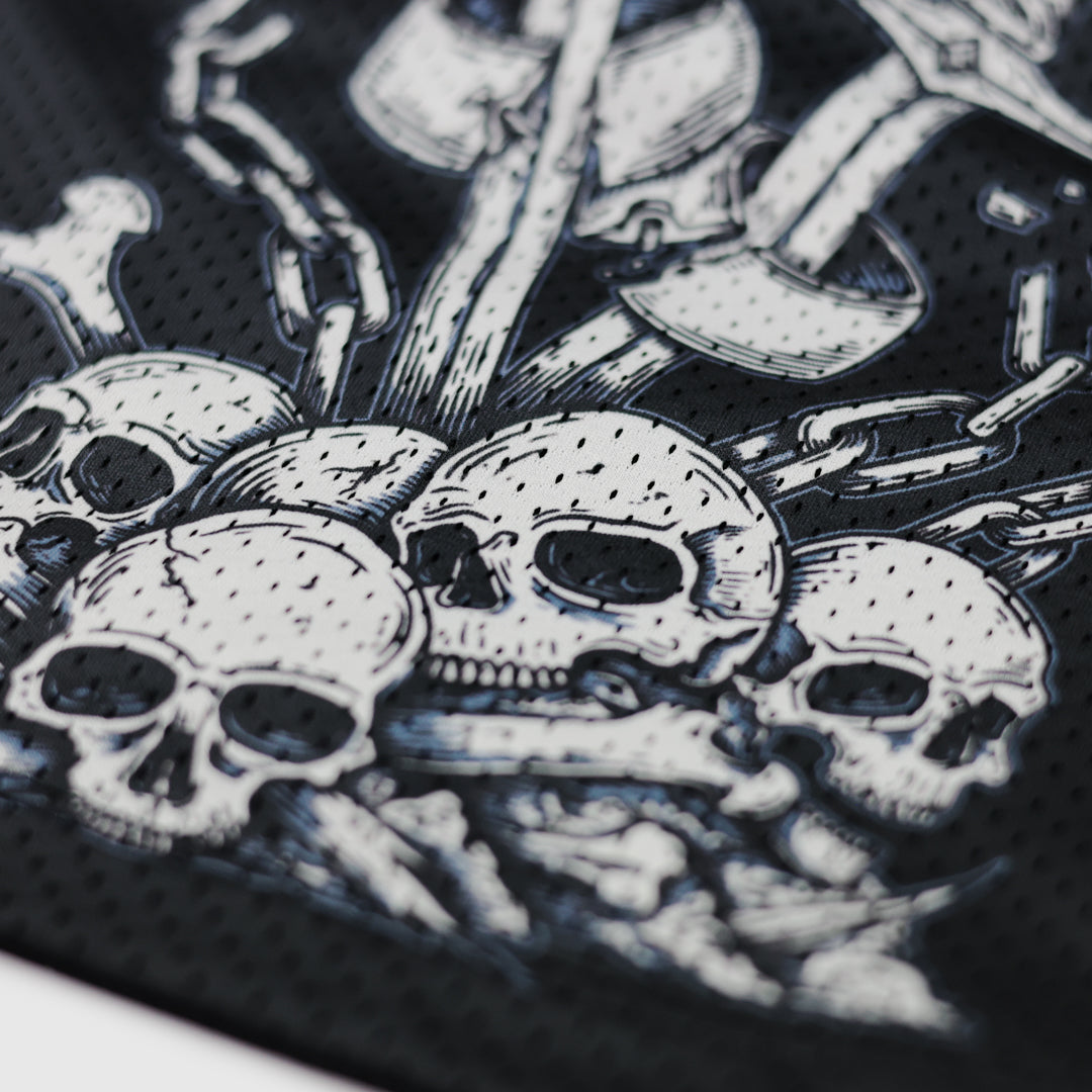 Close-up of a black and white graphic design featuring skulls and bones on a textured background.
