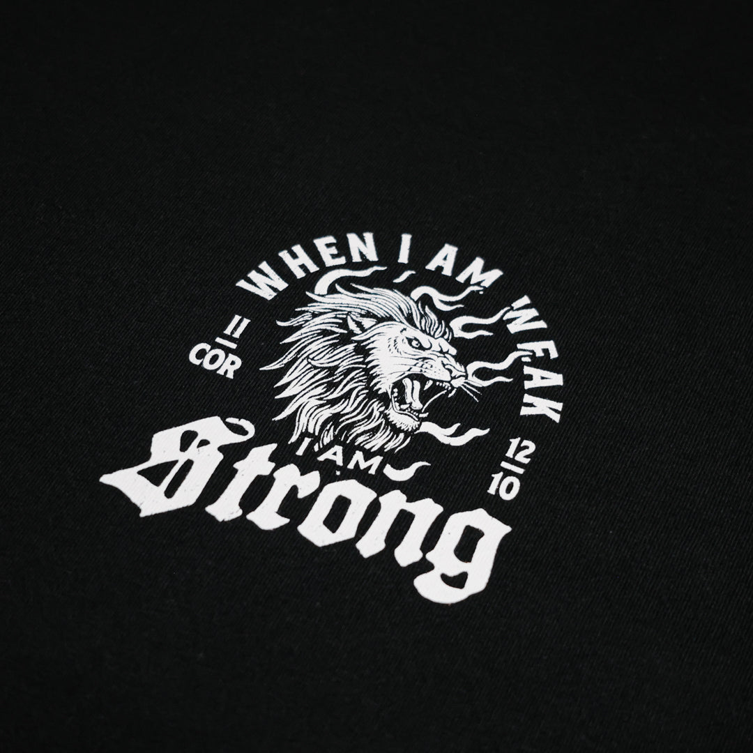 Black t-shirt with white lion graphic and 2 Corinthians 12:10.