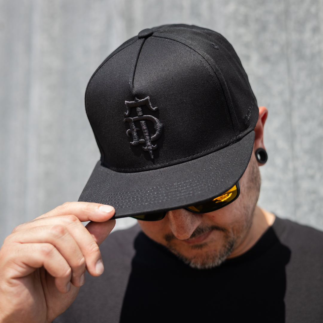 Black on black puff embroidered Disciple Threads monogram logo flat bill hat. Features "Freedom in Truth" embroidered on the side.