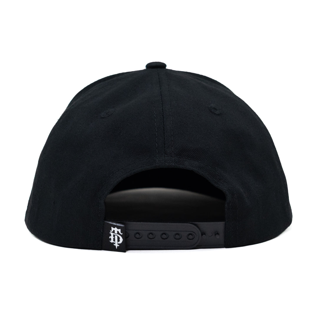 Black snapback cap shown from the back, featuring a black fabric crown, black visor, and an adjustable black strap with a small white embroidered logo.