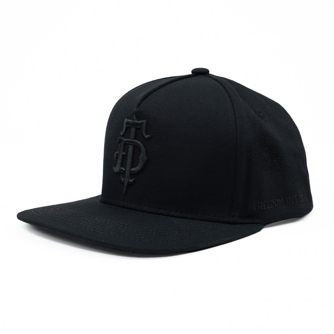Black on black puff embroidered Disciple Threads monogram logo flat bill hat. Features "Freedom in Truth" embroidered on the side.