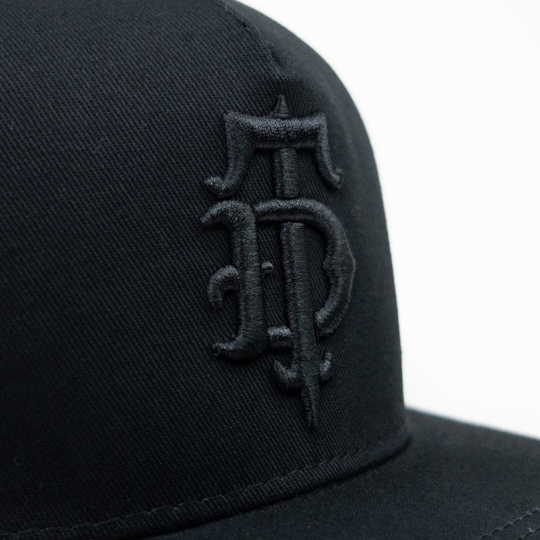 Black on black puff embroidered Disciple Threads monogram logo flat bill hat. 