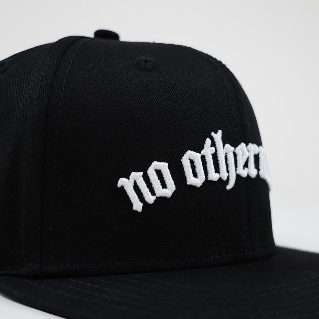 Black cap with 'no other name' text on a white background