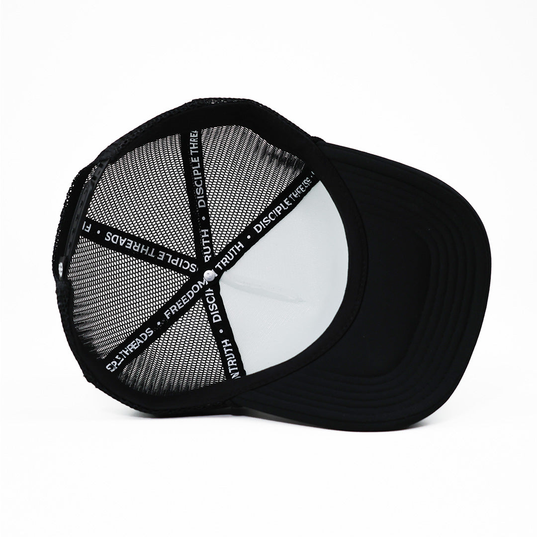 Black cap with mesh back and visible branding on a white background